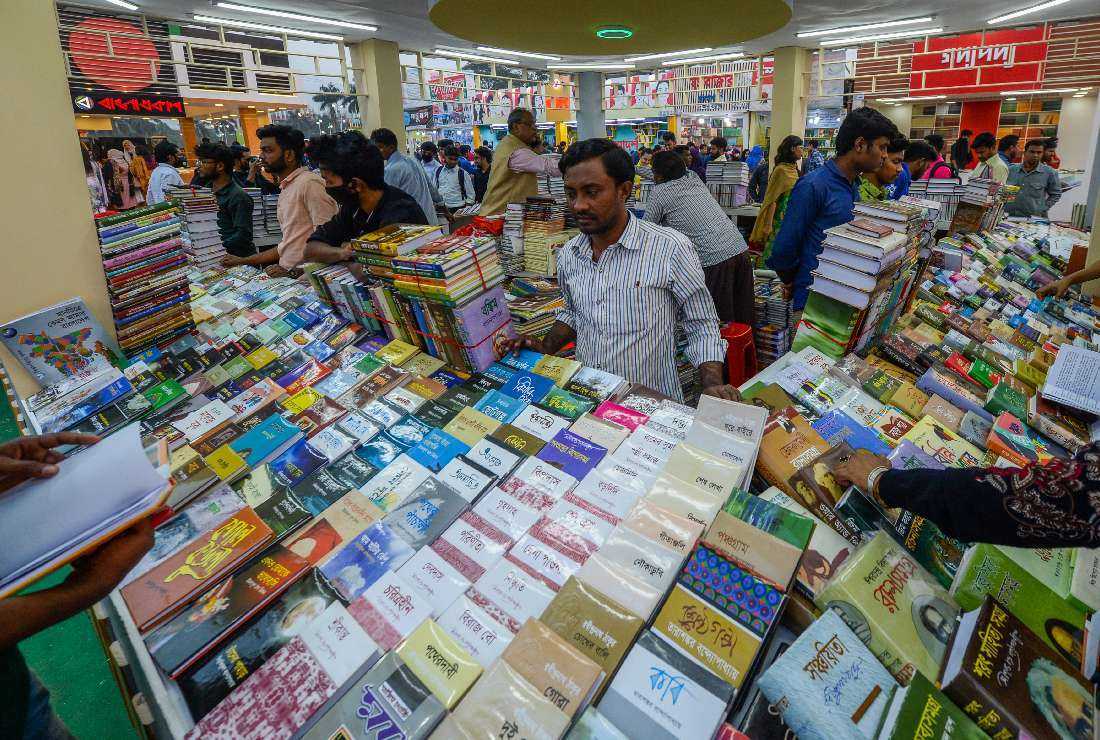 Shoppers check books at a stall during Ekushey Boi Mela book fair in Dhaka on Feb. 16, 2022