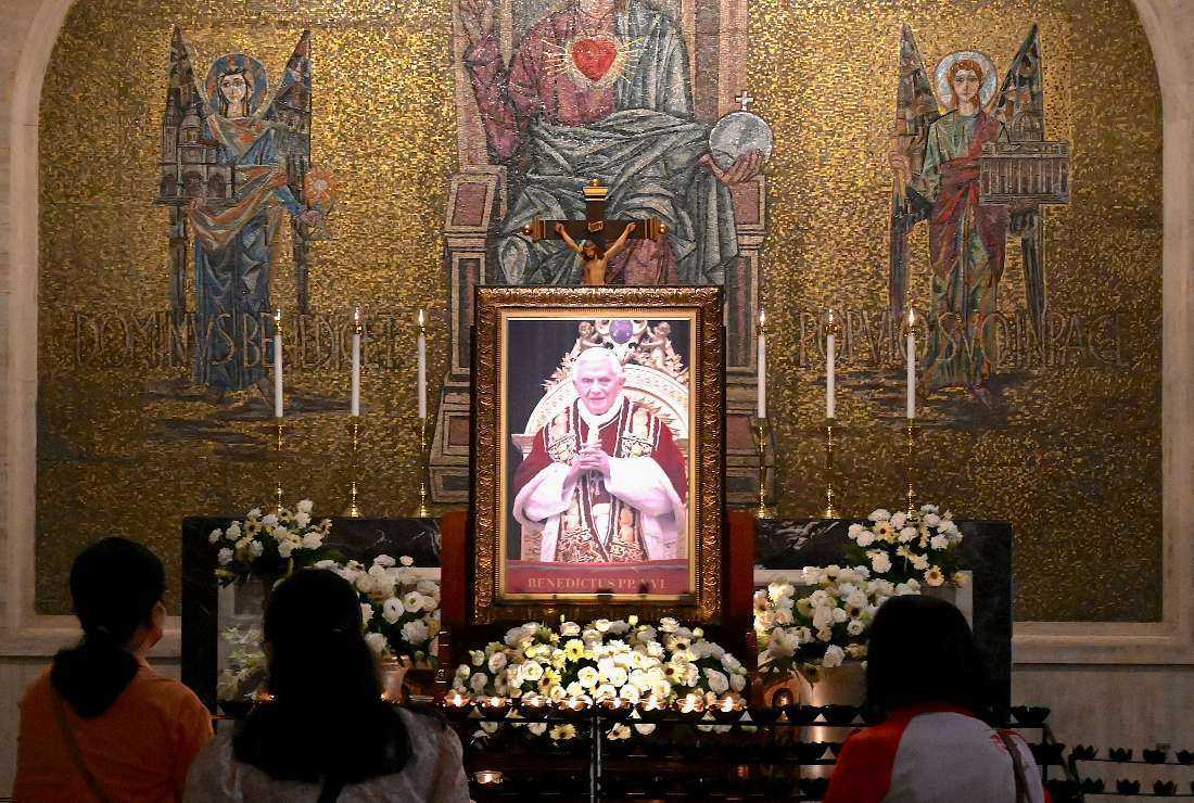 People light candles for the late Pope Benedict XVI at Manila Cathedral in Manila on Jan. 3