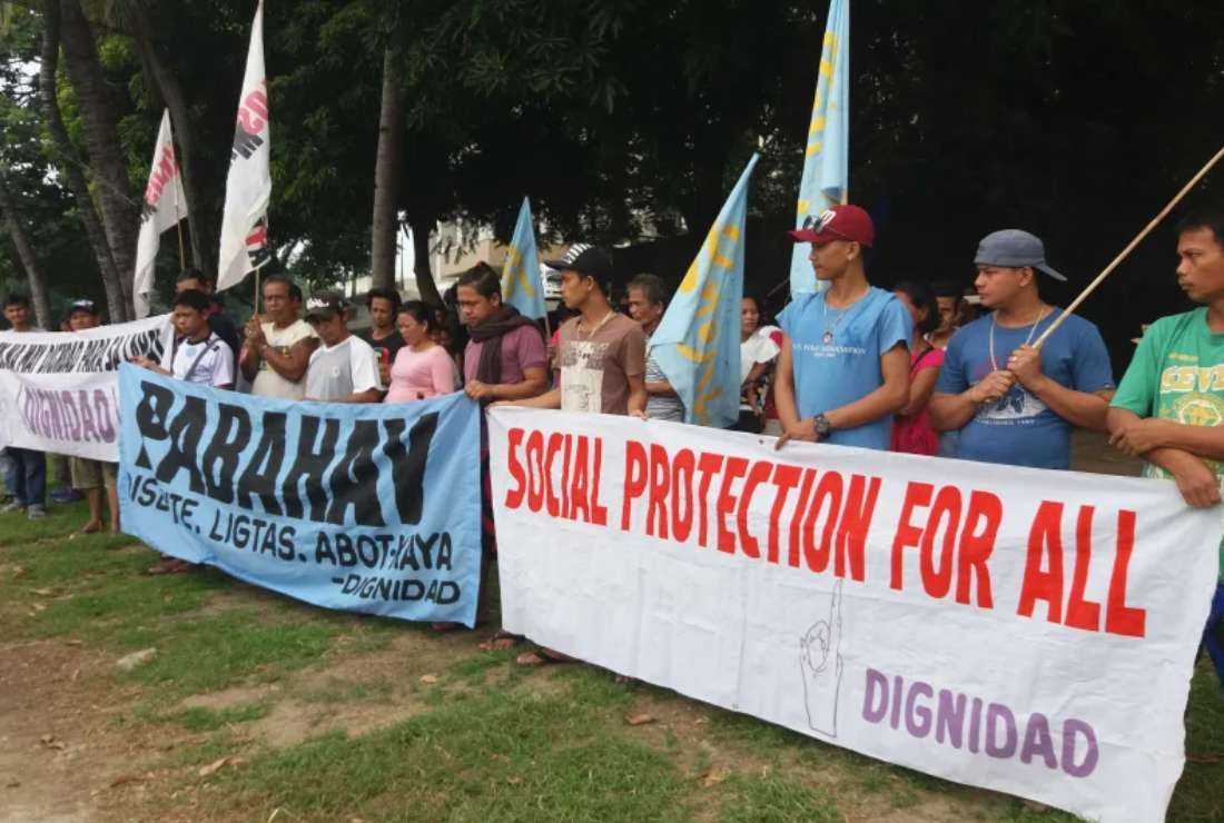 Members of Dignidad Pilipinas and other civil society organizations in Manila walk to the venue of the ASEAN Conference on Social Protection at Sofitel Hotel on Aug. 16, 2017, to hand over their recommendations and demands concerning social protection measures for the poor