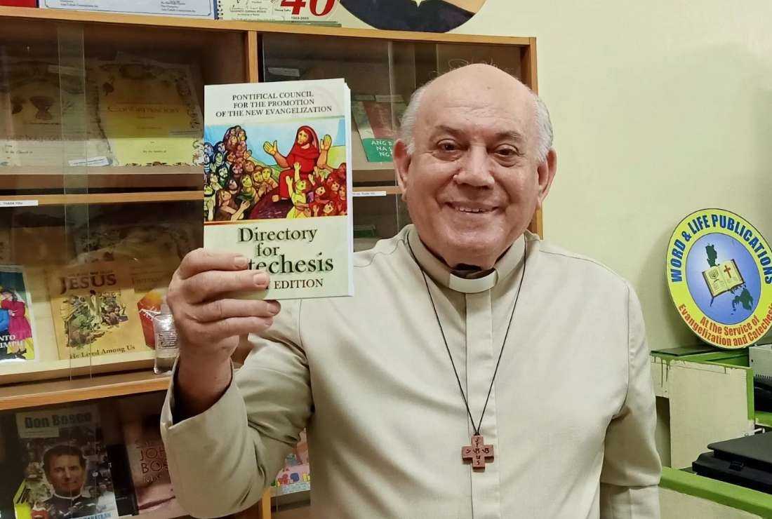 Italian Salesian priest Father Salvatore Putzu (1938-2023) holds the Directory for Catechists in this file photo