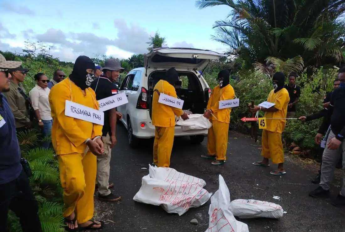 A group of activists is seen reconstructing the crime scene of the killing of four Protestant Christians in Papua province in Indonesian