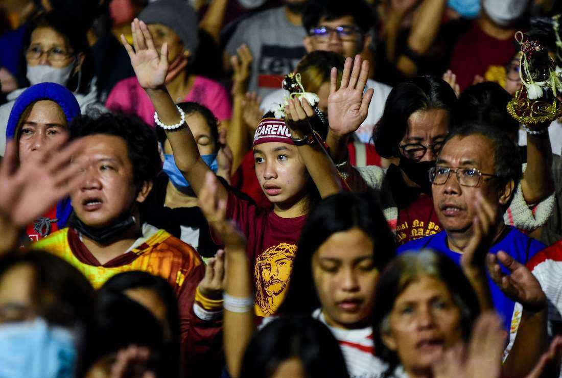 jesus on the cross images - Filipino Catholics participate in a midnight Mass on Jan. 9 during the Black Nazarene feast in Manila