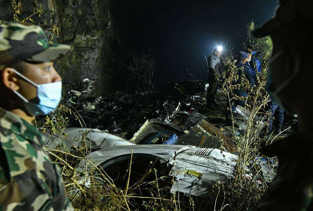 Rescuers inspect the wreckage at the site of a Yeti Airlines plane crash in Pokhara on Jan. 15