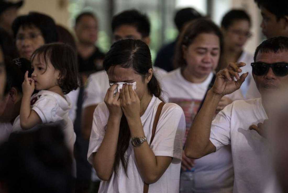 The sister of teenager Carl Arnaiz, who was shot and killed after he allegedly robbed a taxi driver at gunpoint, weeps during a Mass ahead of his burial at the Mater Dolorosa Parish in Manila in 2017