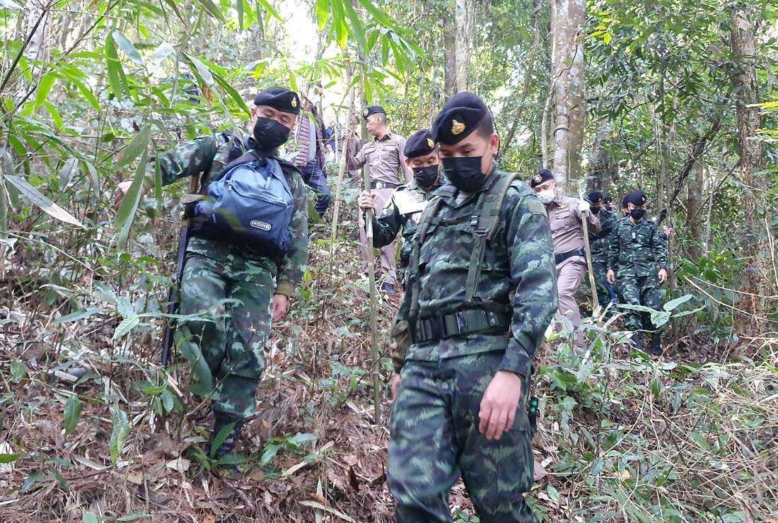 This handout photo taken and released on Jan. 12 by the Royal Thai Army shows members of the Pha Muang Task Force and Thai security personnel walking through a forested area of Chiang Rai province in northern Thailand, following a clash with suspected drug traffickers