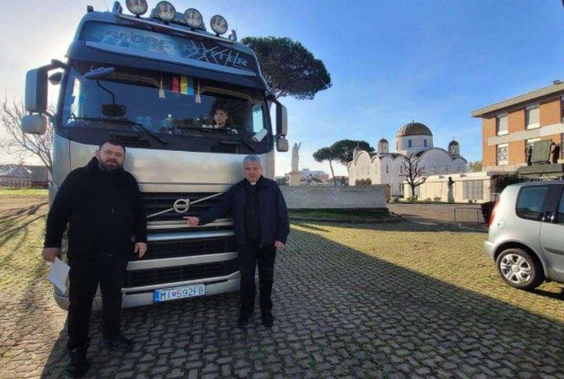Cardinal Konrad Krajewski with the aid vehicle leaving for Ukraine with Rome's Church of Santa Sofia in the background