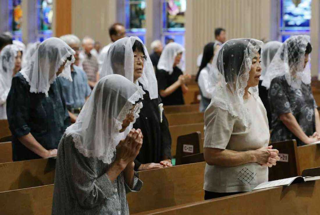 Christians pray for victims during a mass to mark the anniversary of the atomic bombing at the Urakami Cathedral in Nagasaki, western Japan, on Aug. 9, 2017