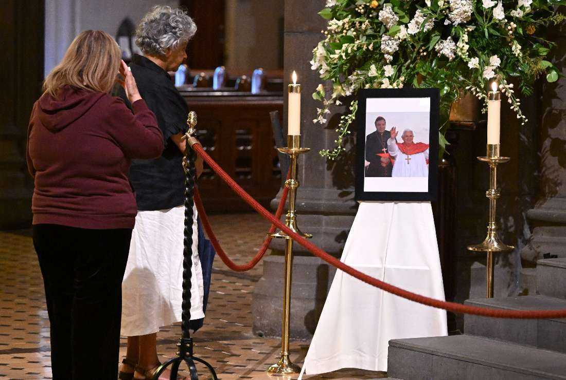 A framed photograph showing Cardinal George Pell (left) with Pope Benedict XVI is seen on display at St Patrick's Cathedral in Melbourne on Jan. 11, as people pay their respects following Pell's death
