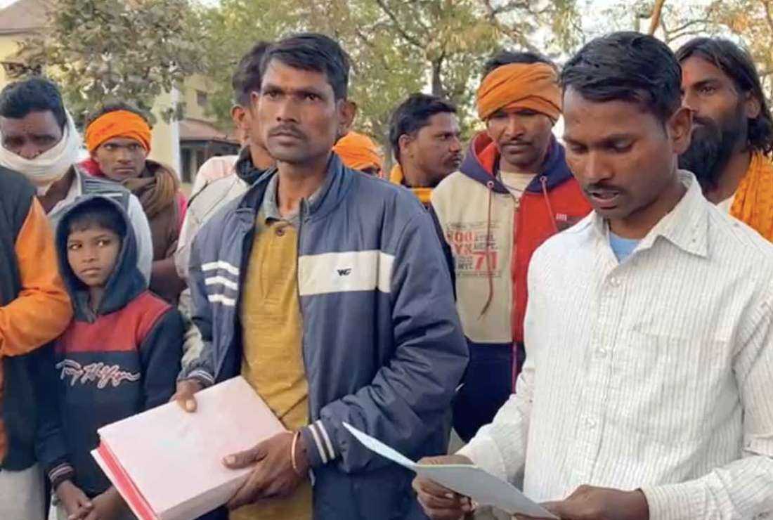 A person reads out the police complaint, which accused Father Joseph Amuthakani Jhabua diocese in central India of distributing the Bible in his attempt to convert Hindus. A person next to him holds the Missal (order of the Mass) they took from the priest's vehicle as evidence of Bible distribution. The priest was arrested on Jan. 18 but was released after ten hours