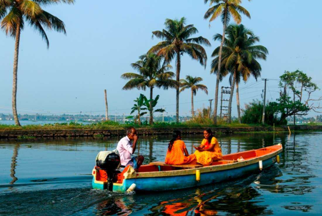 In this picture taken on March 21, 2022, women travel by boat on the backwaters of Alappuzha, Kerala