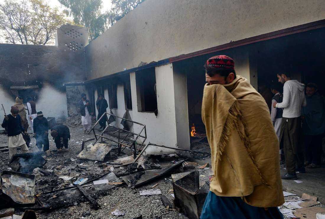 In this file photo, demonstrators gather at a police station that was set on fire after thousands of people mobbed it demanding that officers hand over a man accused of blasphemy for burning a Quran, in Charsadda, in Khyber Pakhtunkhwa province on Nov. 29, 2021