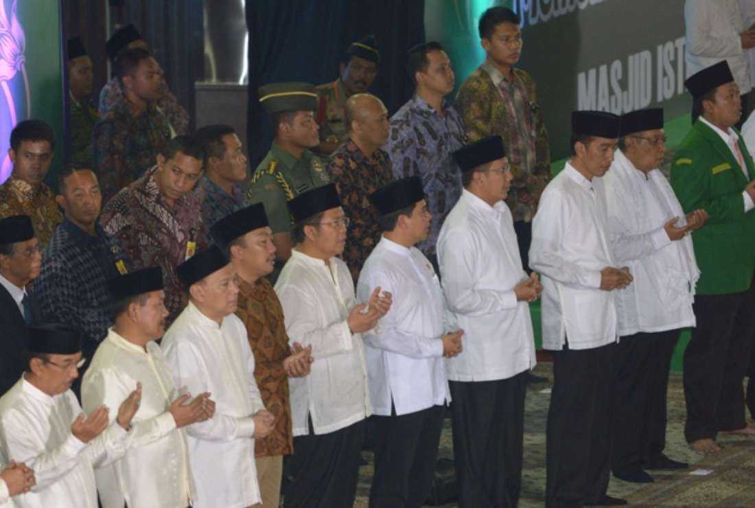 Indonesian President Joko Widodo (front row, third from right) attends a mass prayer held by members of Nahdlatul Ulama (NU), the biggest Muslim organisation in Indonesia, to welcome Ramadan in Jakarta on June 14, 2015