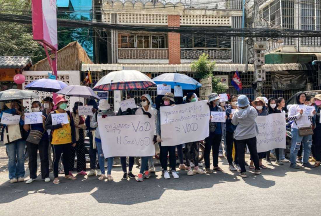 Supporters of online media outlet Voice of Democracy (VOD) hold placards in front of the VOD office in Phnom Penh on Feb. 13 after Cambodian Prime Minister Hun Sen said VOD would have its operating license revoked for a news report about his son