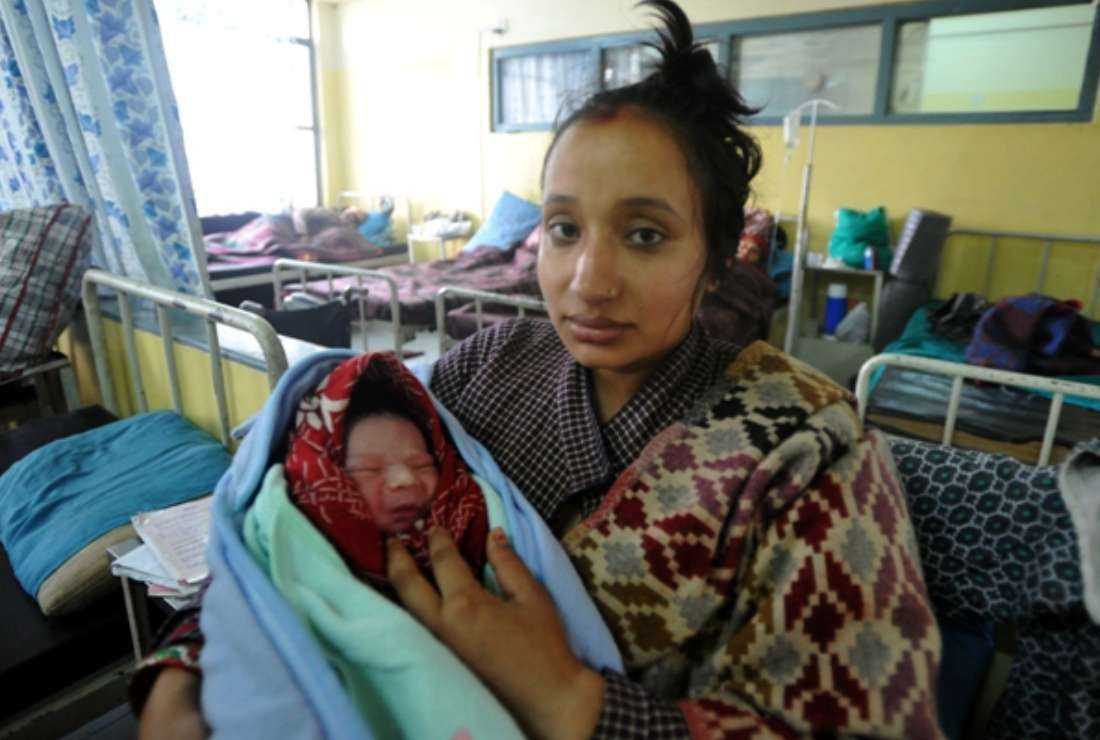 A Nepalese mother holds her newly born baby boy at Nepal Maternity hospital in Kathmandu on Oct. 31, 2011