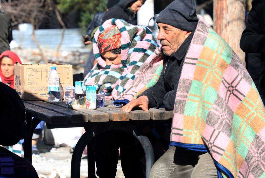 An elderly couple sits at a table in a park in Gaziantep, close to the quake's epicenter, a day after a 7.8-magnitude earthquake struck the country's southeast, on Feb. 7