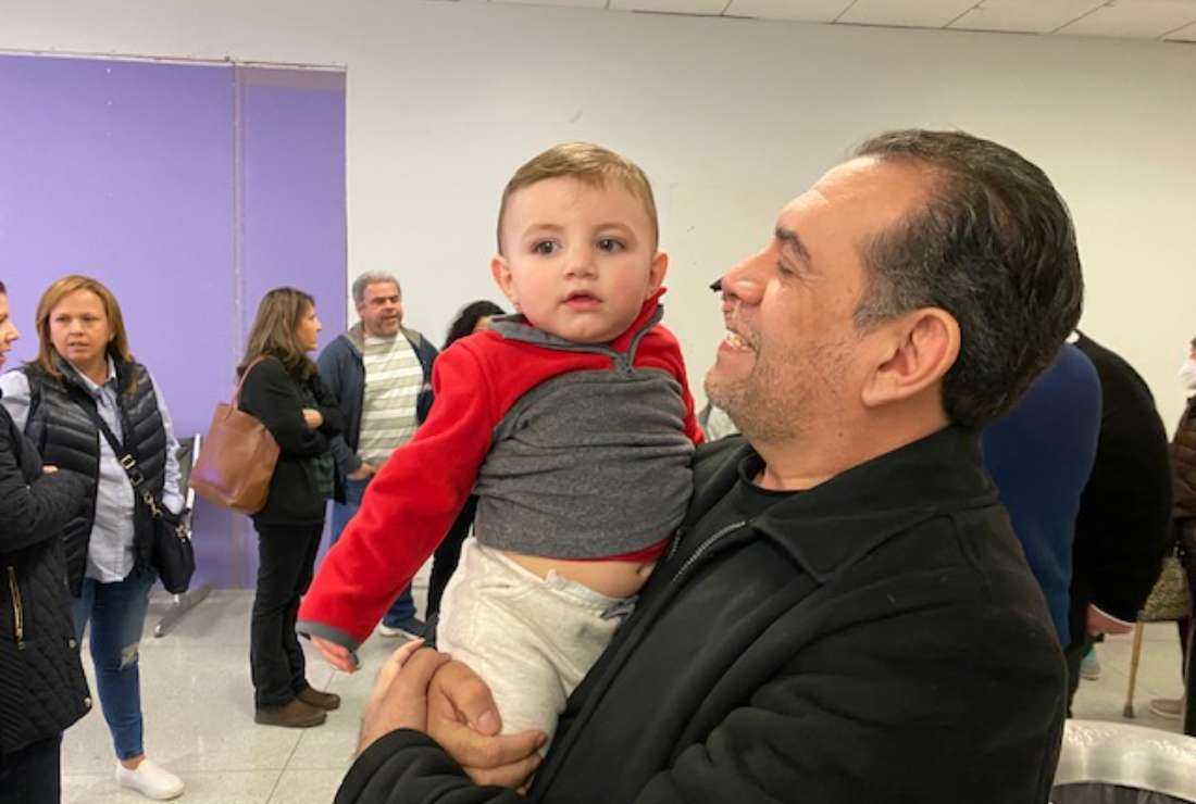 Father Ramiro Tijerino meets his infant nephew Eduardo after arriving at the Charlotte airport Sunday night