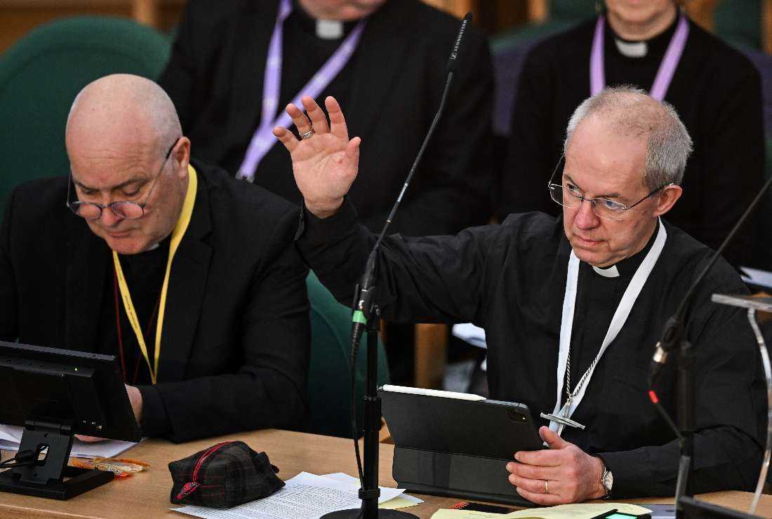 Archbishop of Canterbury Justin Welby (right) raises his arm during the voting of a motion during the Church of England Synod, at Church House, in London, on Feb. 7