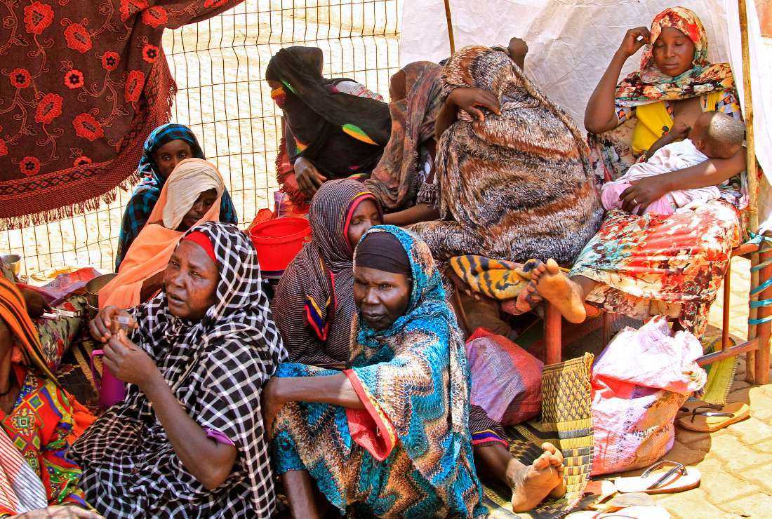 Sudanese take shelter in a stadium after being displaced by flooding in Managil city in al-Gezira state, around 250 km south of the capital Juba, on Aug. 23, 2022
