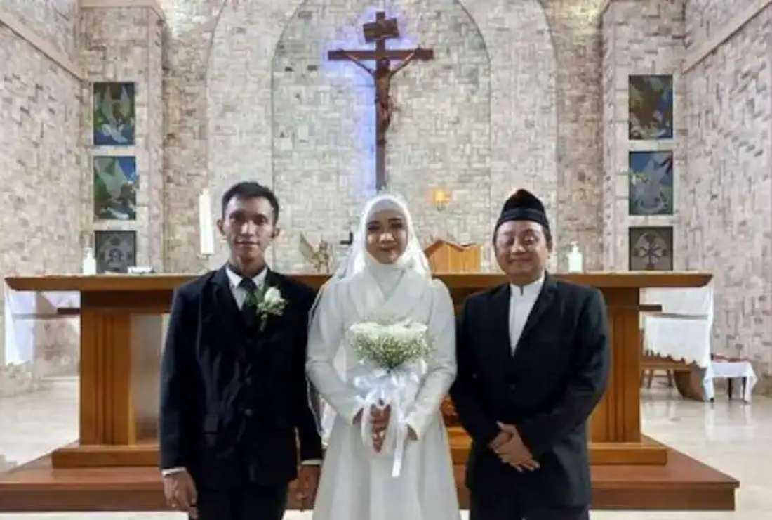 Ahmad Nurcholish, program director and interfaith marriage counselor at Indonesian Conference on Religion and Peace in Indonesia, is seen with an interfaith couple in this file image
