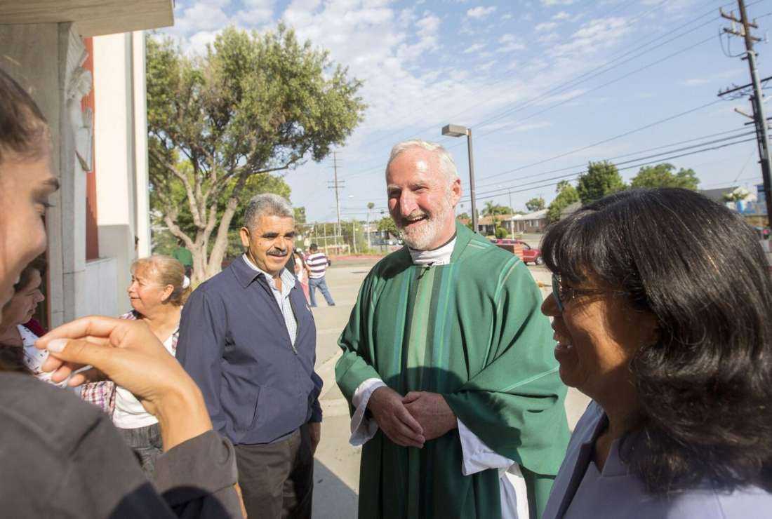 Los Angeles Auxiliary Bishop David G. O'Connell is pictured speaking with parishioners outside St. Frances X. Cabrini Church in Los Angeles July 19, 2015