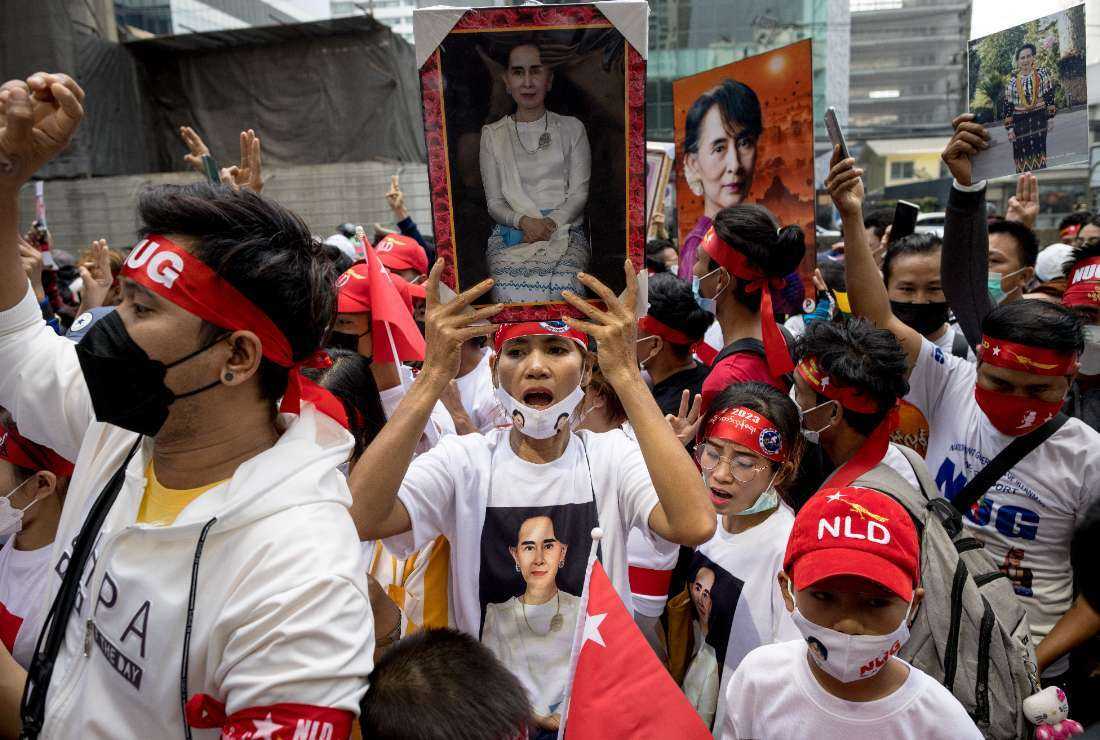 Protesters hold images of detained civilian leader Aung San Suu Kyi during a demonstration outside the Embassy of Myanmar in Bangkok on Feb. 1 to mark the second anniversary of the coup in Myanmar