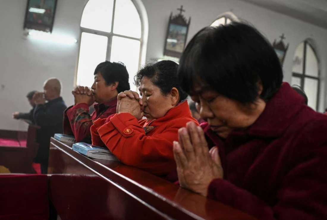 Catholic worshippers attend a morning Mass on Easter Sunday at a Catholic church in a village near Beijing on April 4, 2021
