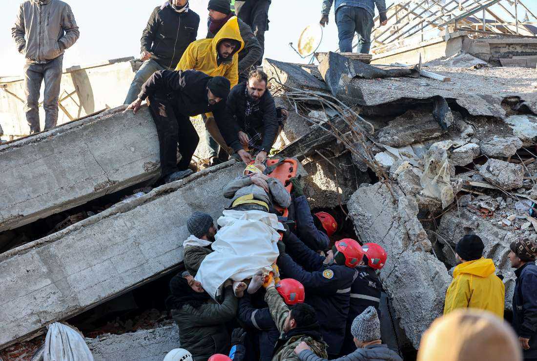 Rescue workers pull out a survivor from the rubble of a destroyed building in Kahramanmaras, southern Turkey, a day after a 7.8-magnitude earthquake struck the country's southeast, on Feb. 7