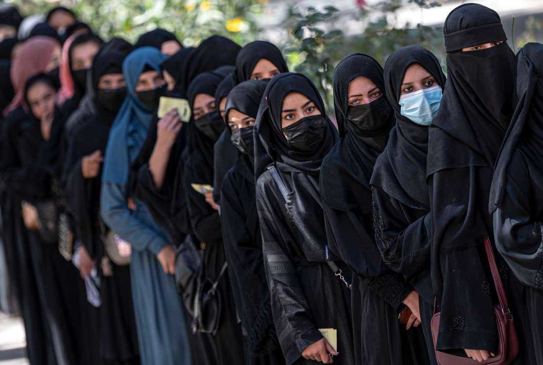 In this file photo taken on Oct. 13, 2022, Afghan female students stand in a queue after arriving for entrance exams at Kabul University in Kabul