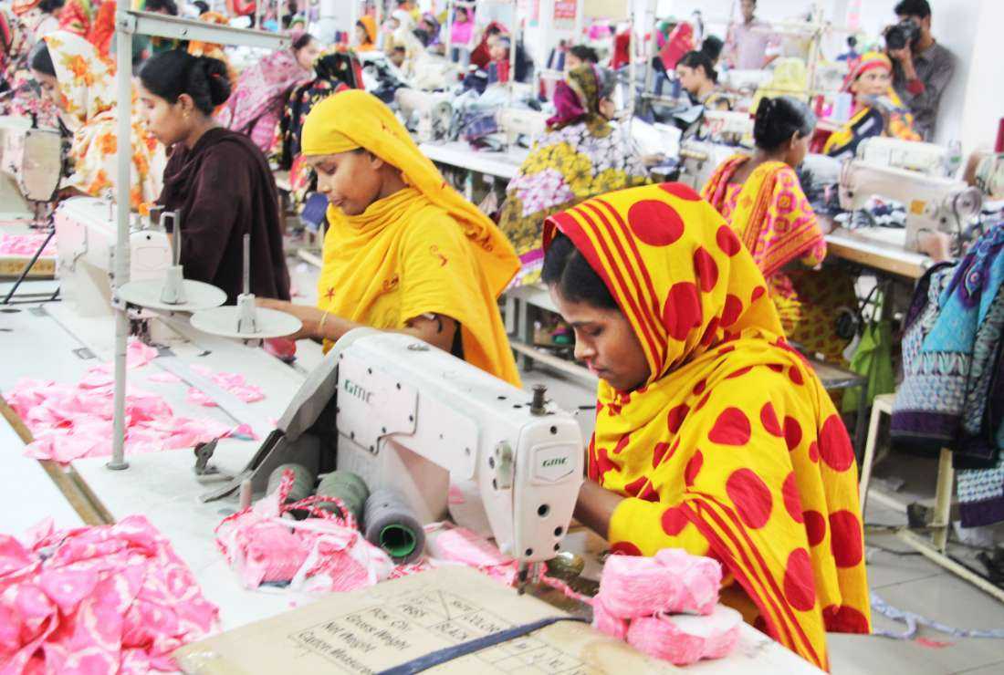Garment workers are busy at work at a factory in the Bangladeshi capital Dhaka in this file image. About 72 percent of women face various forms of abuse at the workplace, says a report from Oxfam