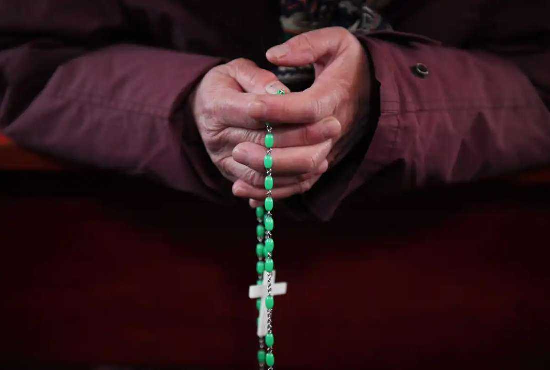 A Catholic worshipper holds a rosary during an Ash Wednesday mass, which marks the beginning of Lent, at Beijing's government-sanctioned South Cathedral on Feb. 14, 2018
