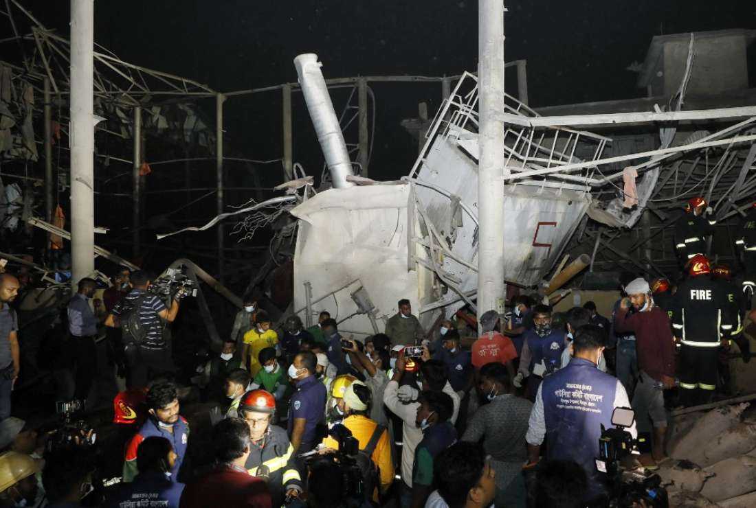 Firefighters and rescue workers gather at the site of an explosion at an oxygen plant on the outskirts of Chittagong on March 4