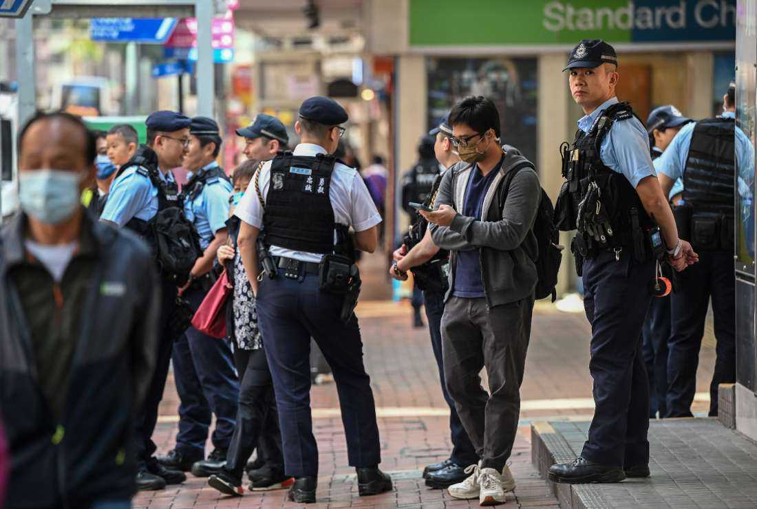 This photo taken on March 5 shows police keeping watch on a street in the Wanchai district after the Hong Kong Women Workers' Association canceled a planned march in the area