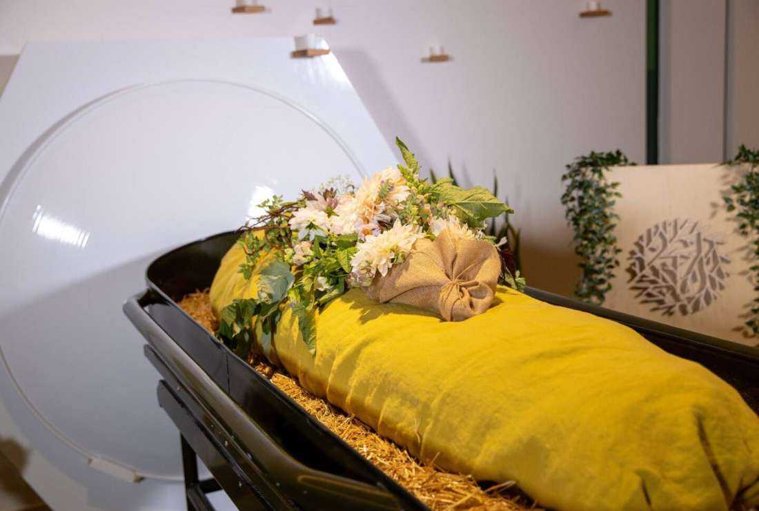 A model of a dead body in front of a human composting vessel at the Recompose green funeral home in Seattle, US