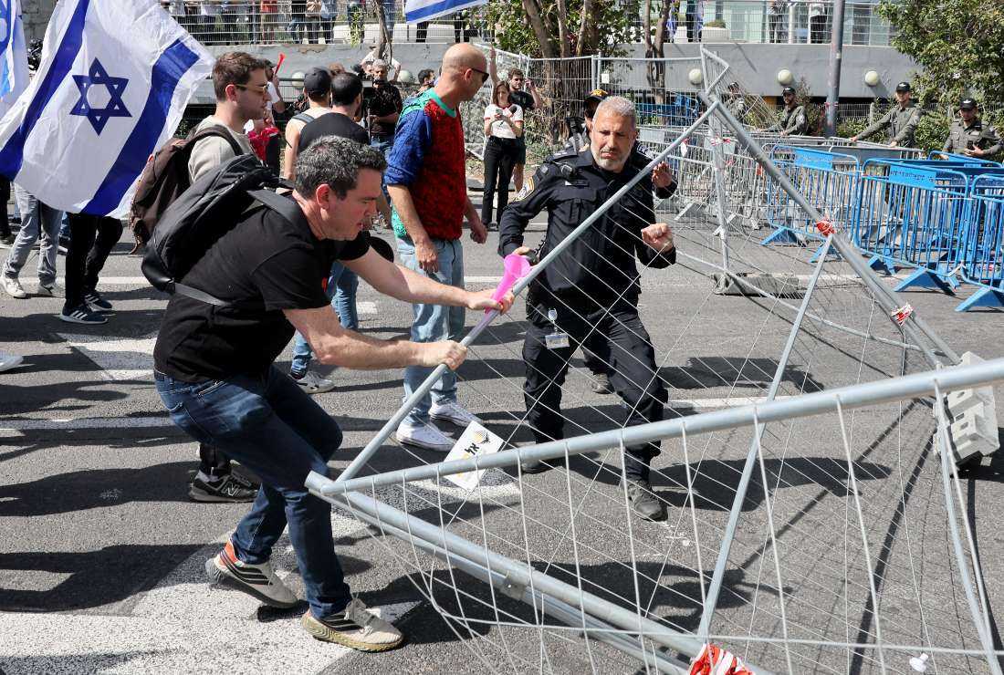 Protesters break police barricades during a demonstration against the Israeli government's controversial justice reform bill in Tel Aviv on March 1