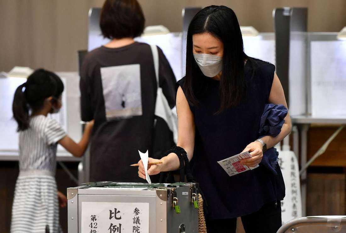 A voter casts her ballot in the Upper House election at a Tokyo polling station on July 10 last year. Only about 10 percent of lawmakers in Japan's 456-seat parliament are females
