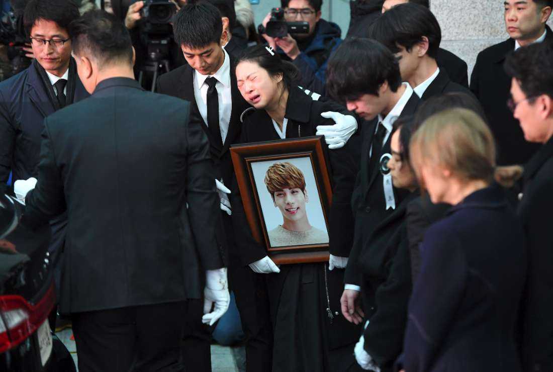 Family members and friends of late SHINee singer Kim Jong-hyun cry as they carry out his coffin during his funeral at a hospital in Seoul on Dec. 21, 2017. The singer committed suicide three days earlier