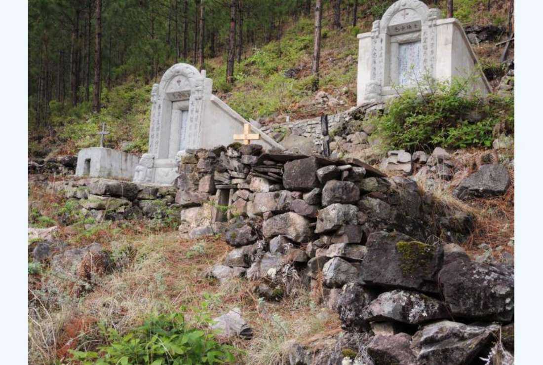 Catholic graves in the mountain cemetery above Cigu church, Yunnan, China. The authorities in Macau started eco-friendly burying of ashes in a cemetery free of charge