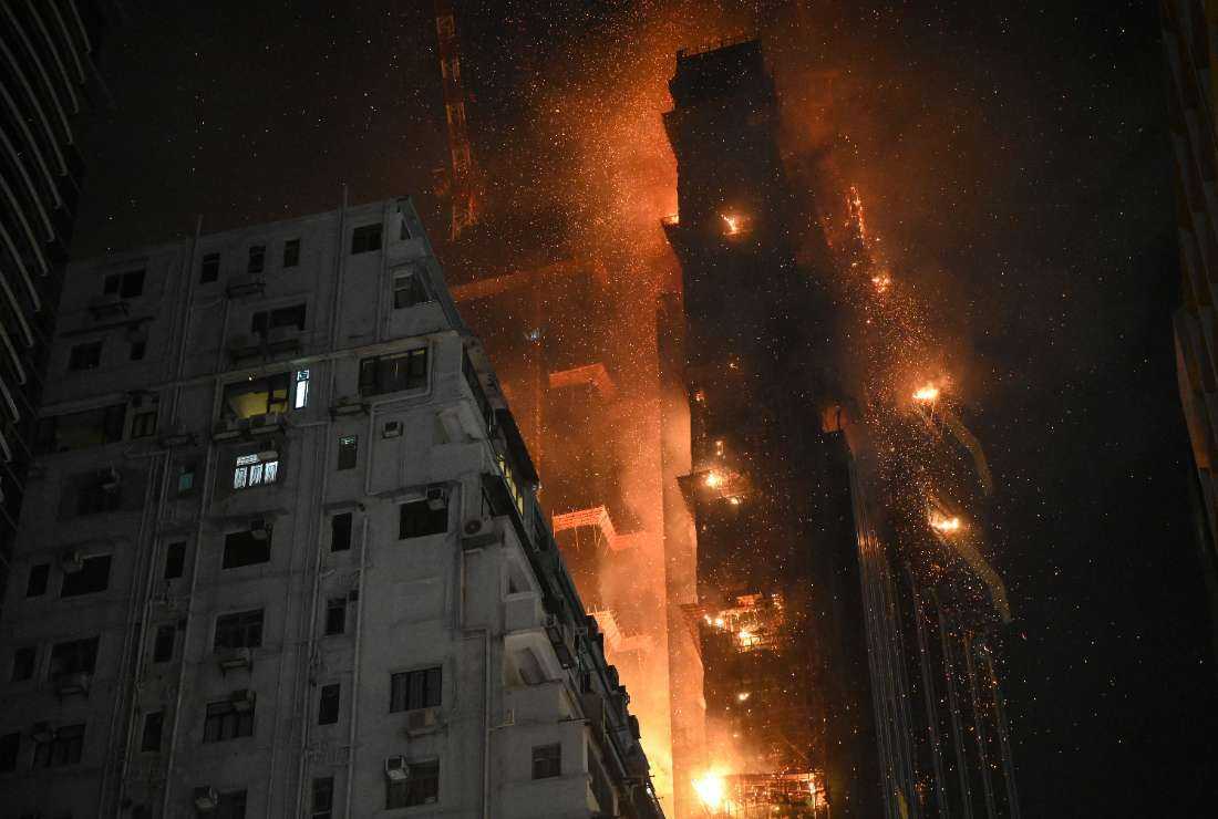 A fire burns at a high-rise building under construction in the Tsim Sha Tsui district in Hong Kong on March 3