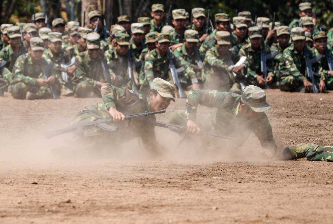 In this photo taken on March 8, members of ethnic rebel group Ta'ang National Liberation Army (TNLA) take part in a training exercise at their base camp in the forest in Myanmar's northern Shan State