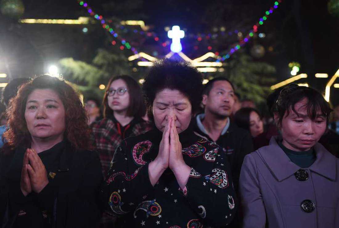 Chinese Catholics attend a mass on Holy Saturday, part of Easter celebrations at Beijing's government-sanctioned South Cathedral on March 31, 2018