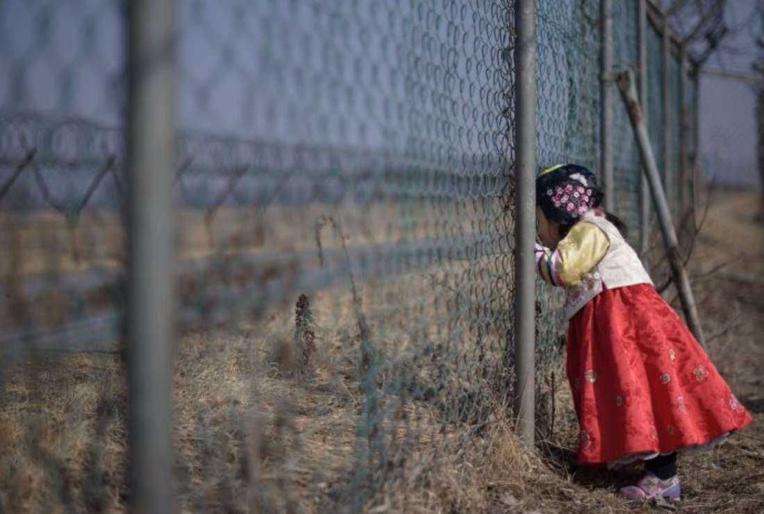 A North Korean girl is seen at the border fence in this file image. Thousands of North Korean women and girls have been trafficked into sex trade in a red zone in northern China, rights groups say
