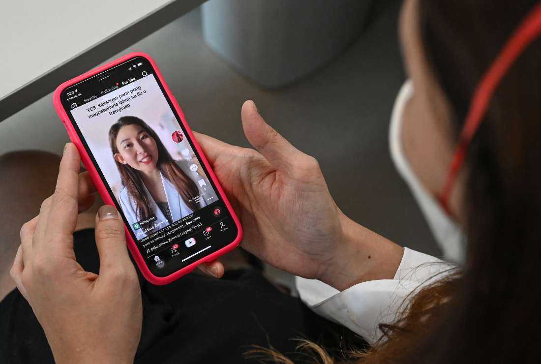 This photo taken on Nov. 3, 2022, shows rheumatologist Geraldine Zamora showing one of her TikTok videos on her smartphone during an interview with AFP at a hospital in Manila