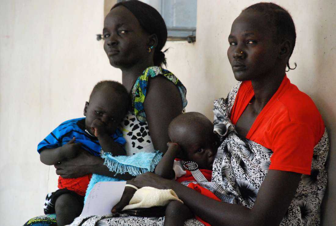 South Sudanese mothers wait with their children to see a nurse in the teaching hospital of the south’s capital Juba on July 1, 2011