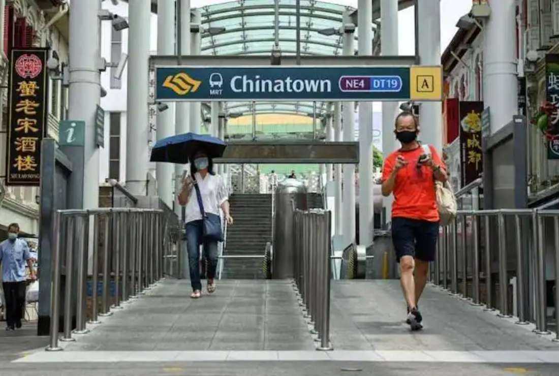 People walk out of the SMRT subway station in the Chinatown district of Singapore. The city-state has seen a series of arrests and convictions over child abuse in recent years