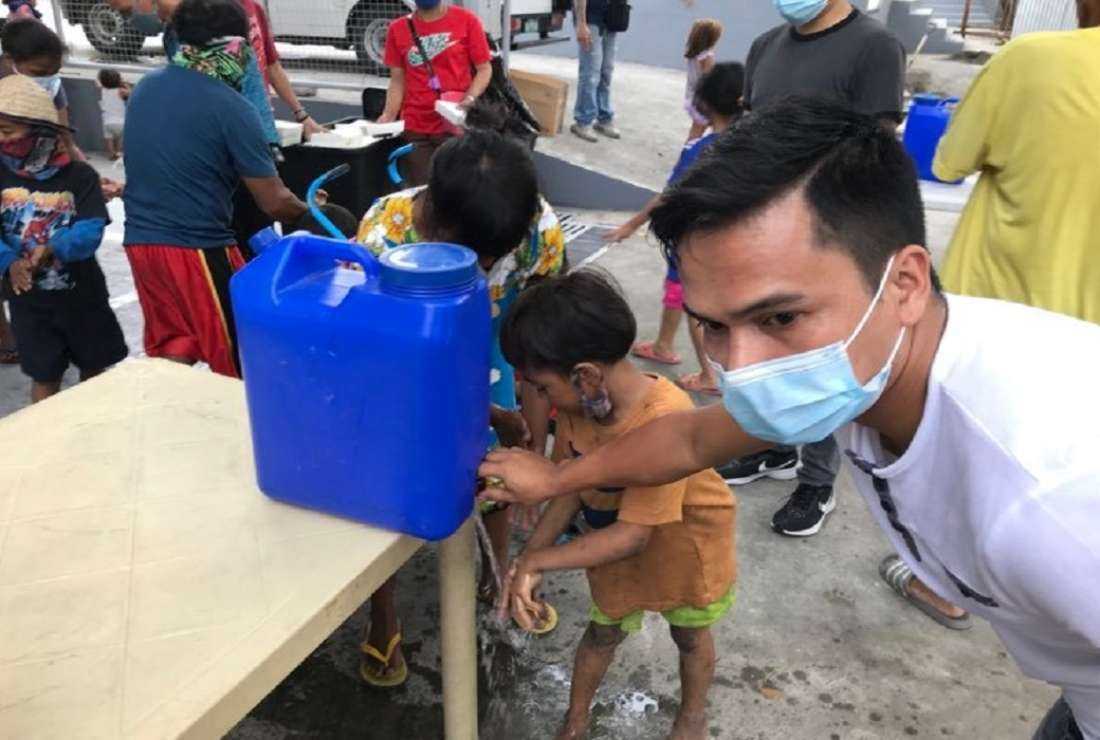 Street children are seen here getting a drink before receiving food from Louisian Foundation volunteers in Manila