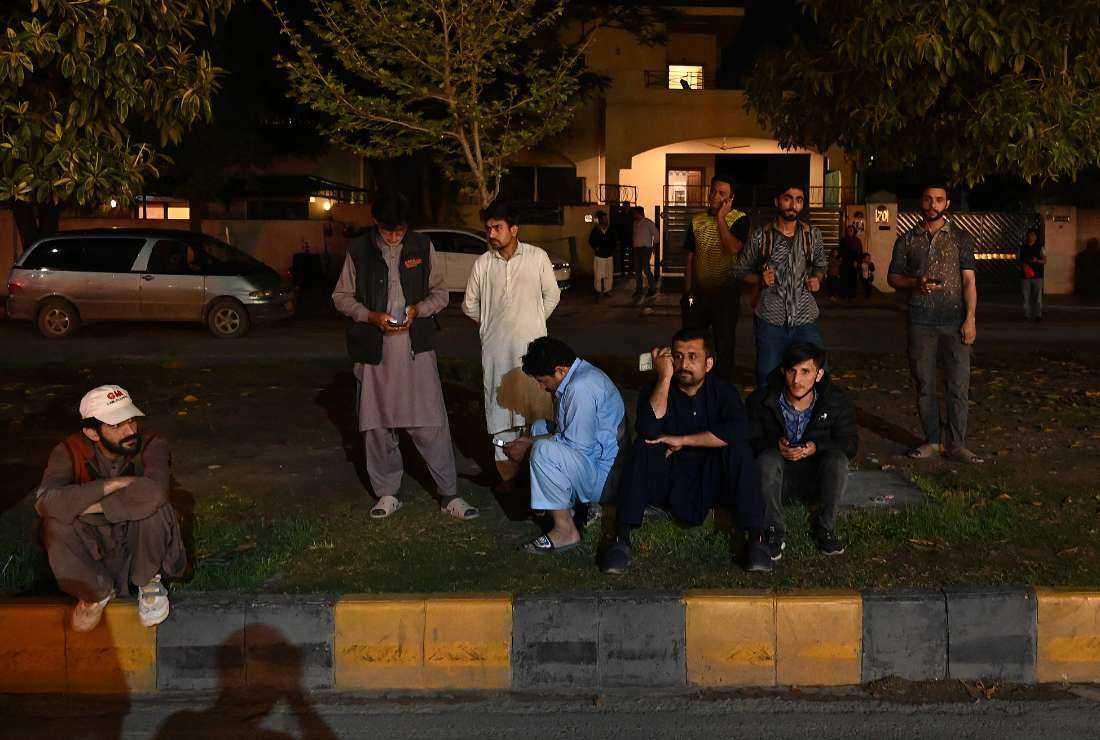 People gather outside a mall following an earthquake in Islamabad, Pakistan, on March 21, 2023