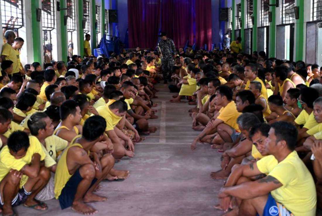 Prison inmates sit inside a compound chapel as police conduct a search operation in the cells for contraband and illegal drugs at the Manila City Jail in Manila on Oct. 21, 2022