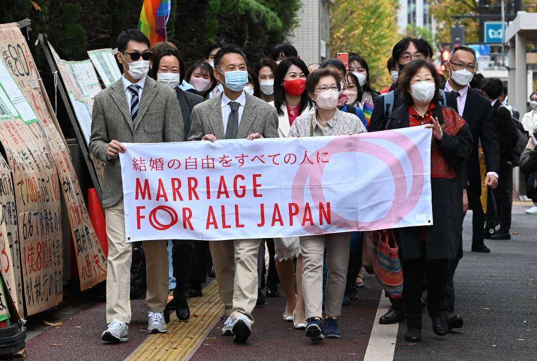 Plaintiffs and their supporters head to the Tokyo District Court in Tokyo on Nov. 30, 2022, in a lawsuit filed by same-sex couples seeking damages from the government arguing the ban on same-sex marriage is unconstitutional