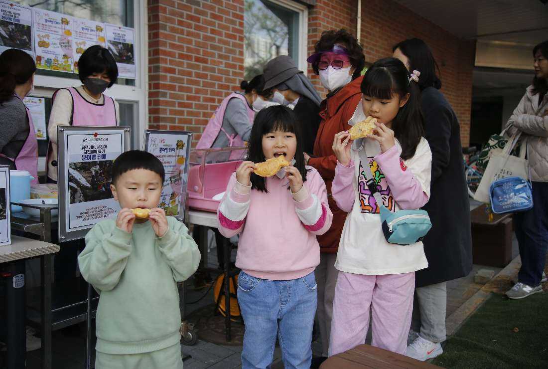 Children from a local school buying freshly baked pastries from nuns at the Salesian Education and Spirituality Center at Singil-dong of Seoul as part of a fundraising campaign for children in earthquake-hit Turkey and Syria