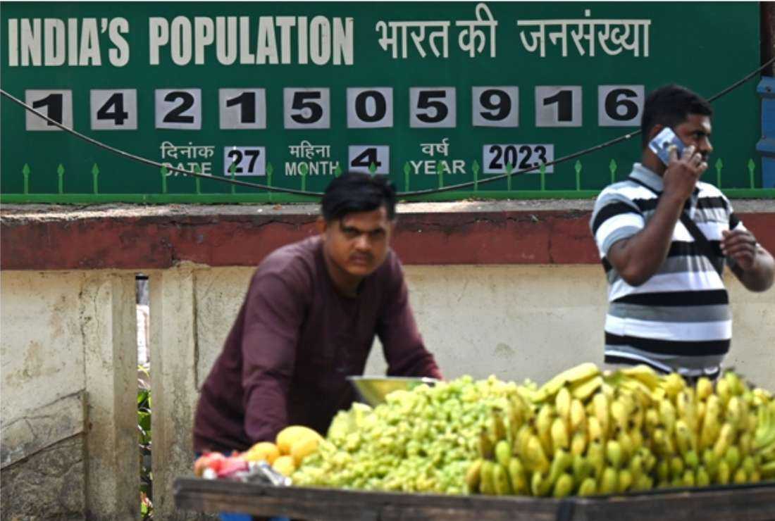 A fruit seller pushes his handcart in front of a population clock board displayed outside the International Institute for Population Sciences (IIPS) in Mumbai on April 27. The United Nations said that India, already boasting 1.43 billion people, would this week overtake China to earn the distinction of being home to more humans than any other country on the planet